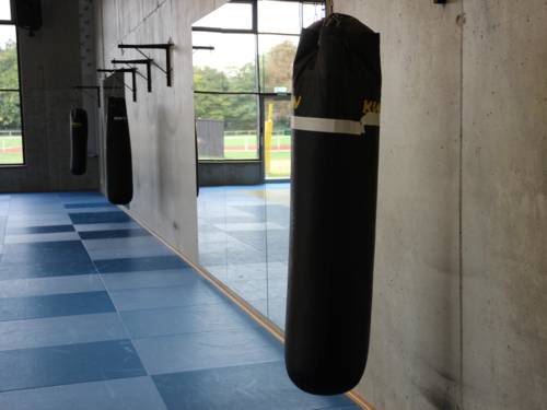 Sandsäcke, die entlang einer Wand aufgehängt sind, zum Training